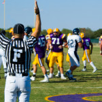 American Football played by young men scoriing a touchdown signaled by game official
